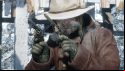 An bearded cowboy wielding two pistols