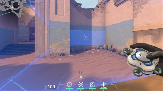 A camera with a blue tint looking at a wall in a crumbling desert area