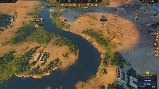 A top-down view of small cities along a river in Total War: Pharaoh.